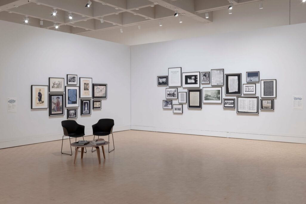 Installation view of the Gallery with framed artwork of printed archival documents displayed in constellations.