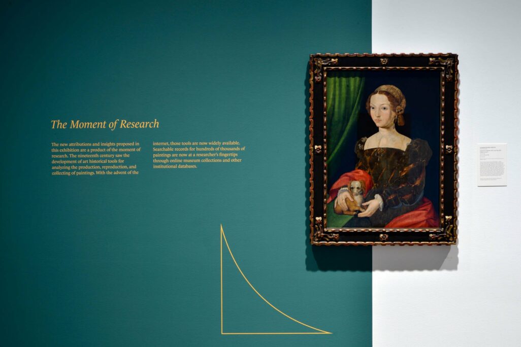 A turquoise coloured wall covers 3/4 of the wall accompanied by a Renaissance painting of a woman in a large ornate frame.